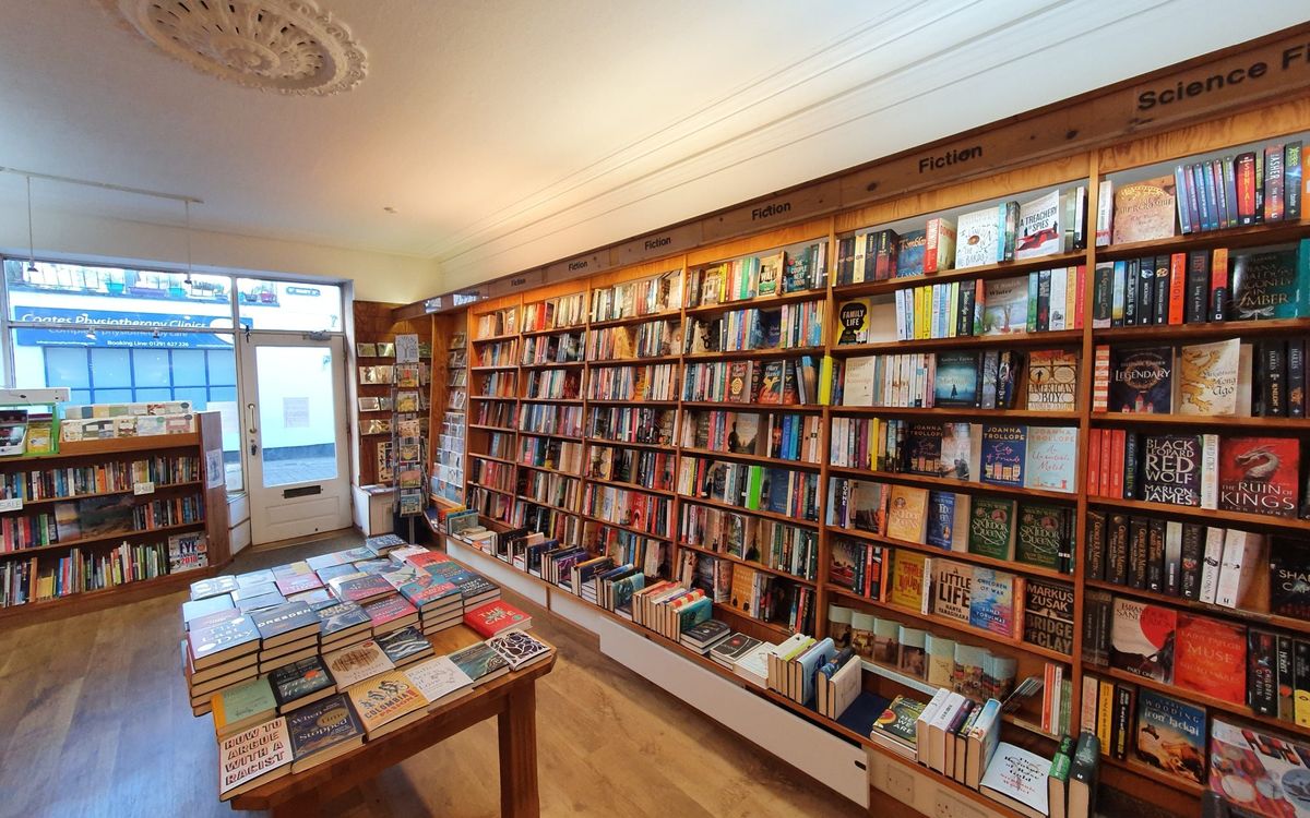 A bookshop interior with floor to ceiling timber shelves